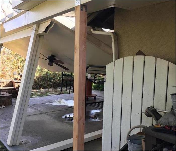 leaning patio cover holding up awning 