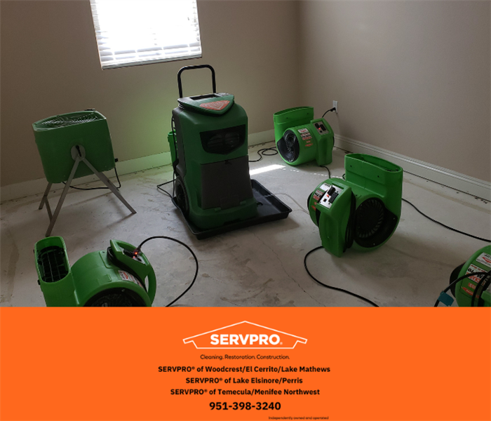 room full of SERVPOS equipment working hard to dry water damage in bedroom ceiling  