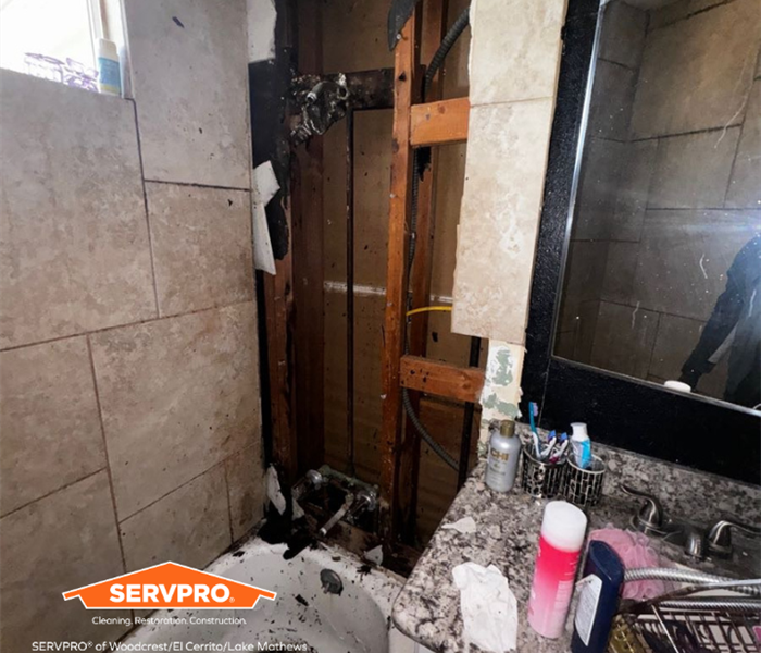 a bathroom shower that took in fire damage and debris is all over the bath tub